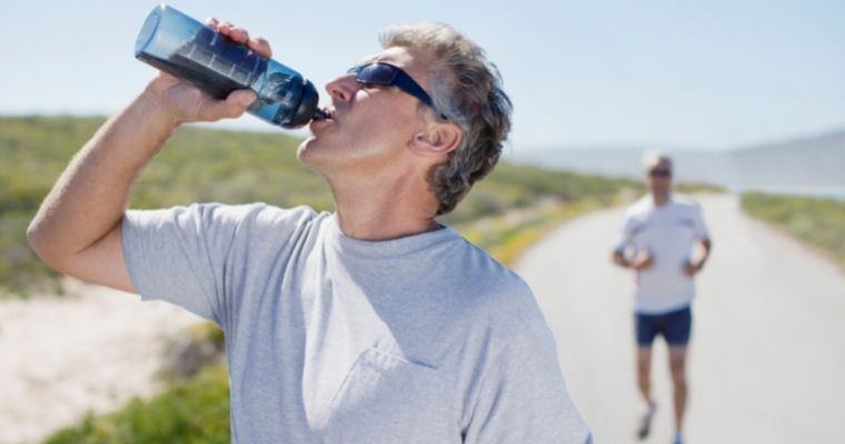 Man drinking water to maintain good oral health
